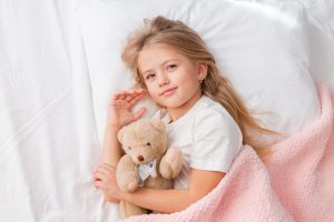 Little,Blonde,Girl,Sleeping,In,Bed,Hugging,A,Teddy,Bear