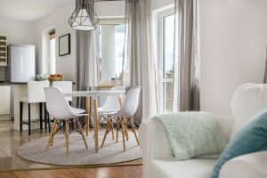 New,Flat,With,Round,Table,,White,Chairs,And,Open,Kitchen